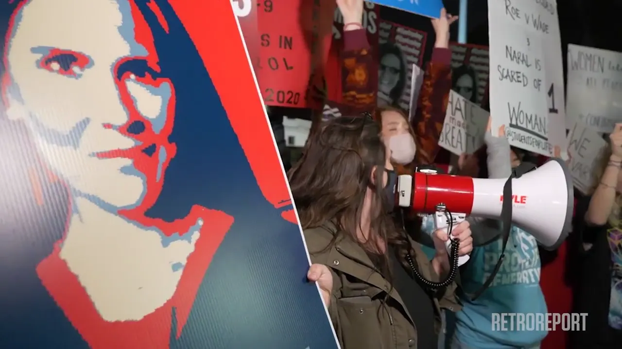A protest with signs reading "ROE V WADE", "WOMAN LIFE FREEDOM", and a "RETROREPORT" logo.