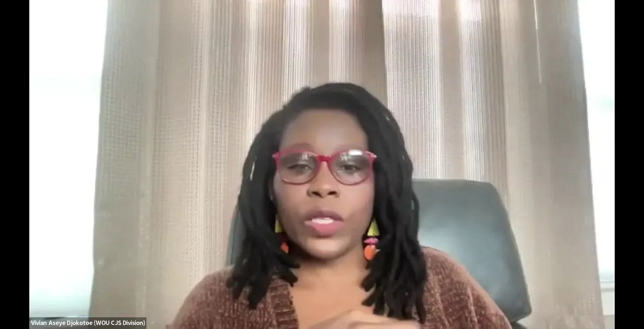 A woman with glasses and dreadlocks is speaking. Text at the bottom reads "Vivian Koreya Djikotose (WOU CJS Division)".